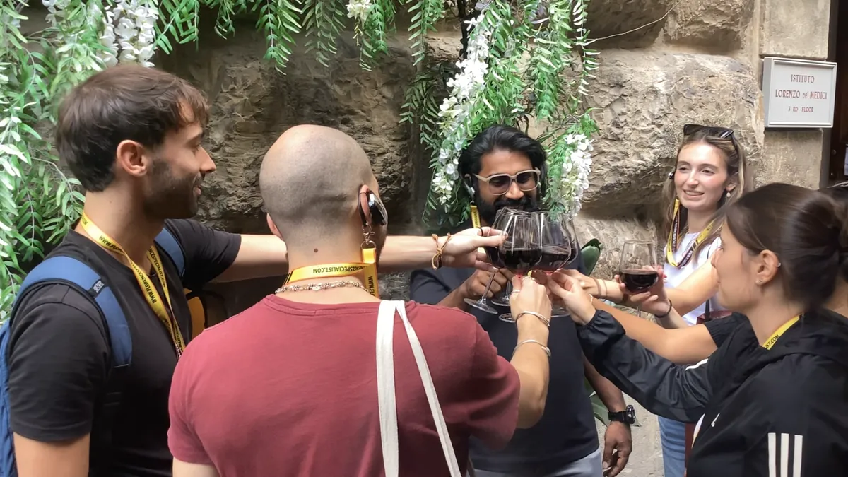 A traditional wine window set into the stone façade of a Florentine palazzo