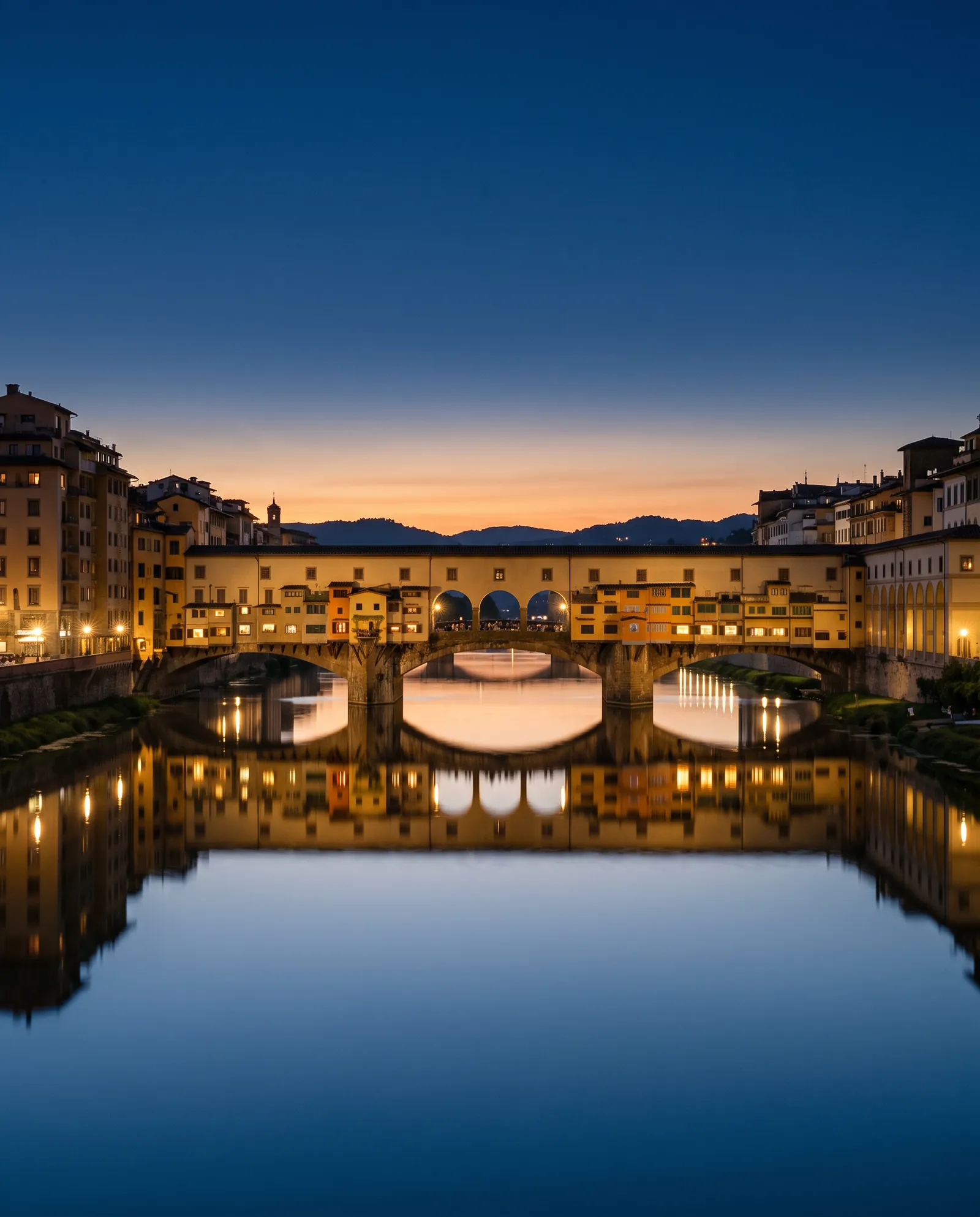 The Ponte Vecchio reflected in the Arno at blue hour